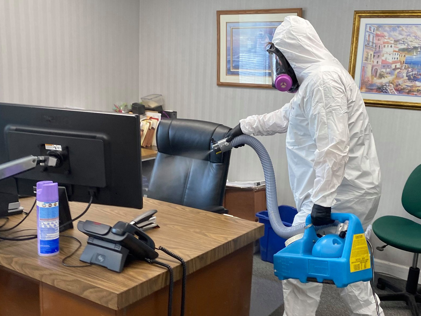 Tech spraying for covid in office